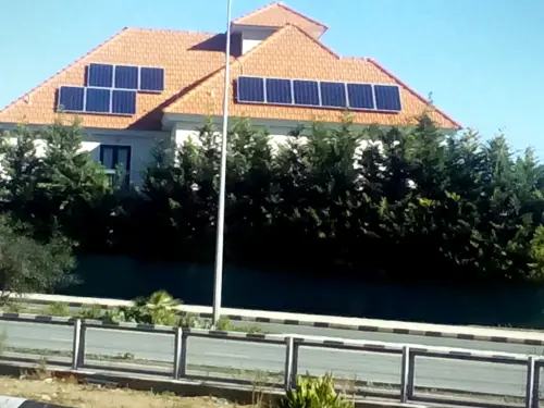 Solar panels on a red-tiled villa roof